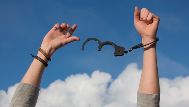 Image of person breaking free of handcuffs