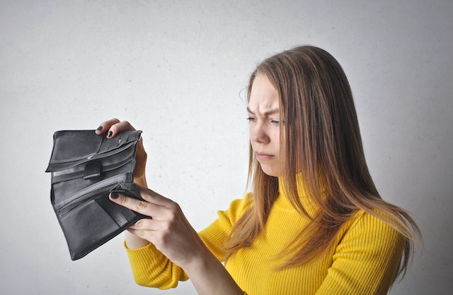 Female looking into an empty wallet